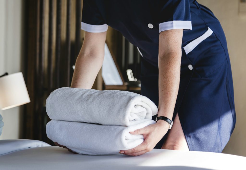 Housekeeper cleaning a hotel room